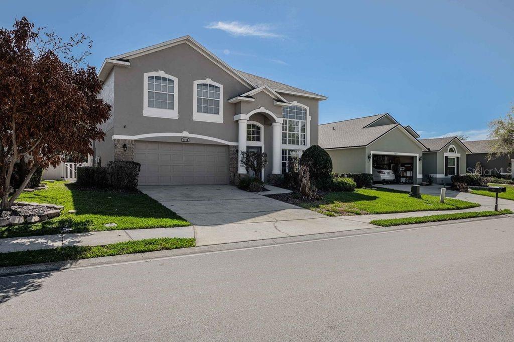 7018 Cascade Court Lakeland, FL 33813 - Photo 2 of 31 a front view of a house with a yard and garage