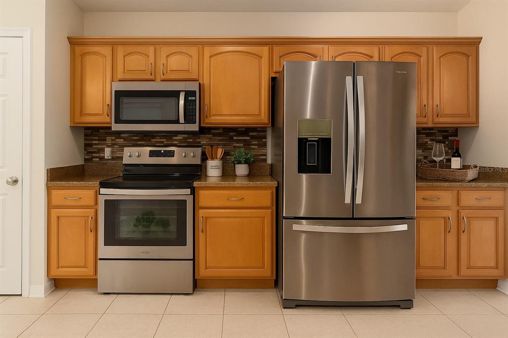 7018 Cascade Court Lakeland, FL 33813 - Photo 7 of 31 a kitchen with stainless steel appliances granite countertop a refrigerator stove and microwave