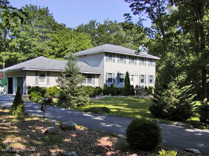 335 Pin Oak Road Stroudsburg, PA 18360 - Photo 17 of 21 a view of a white house with a yard and plants