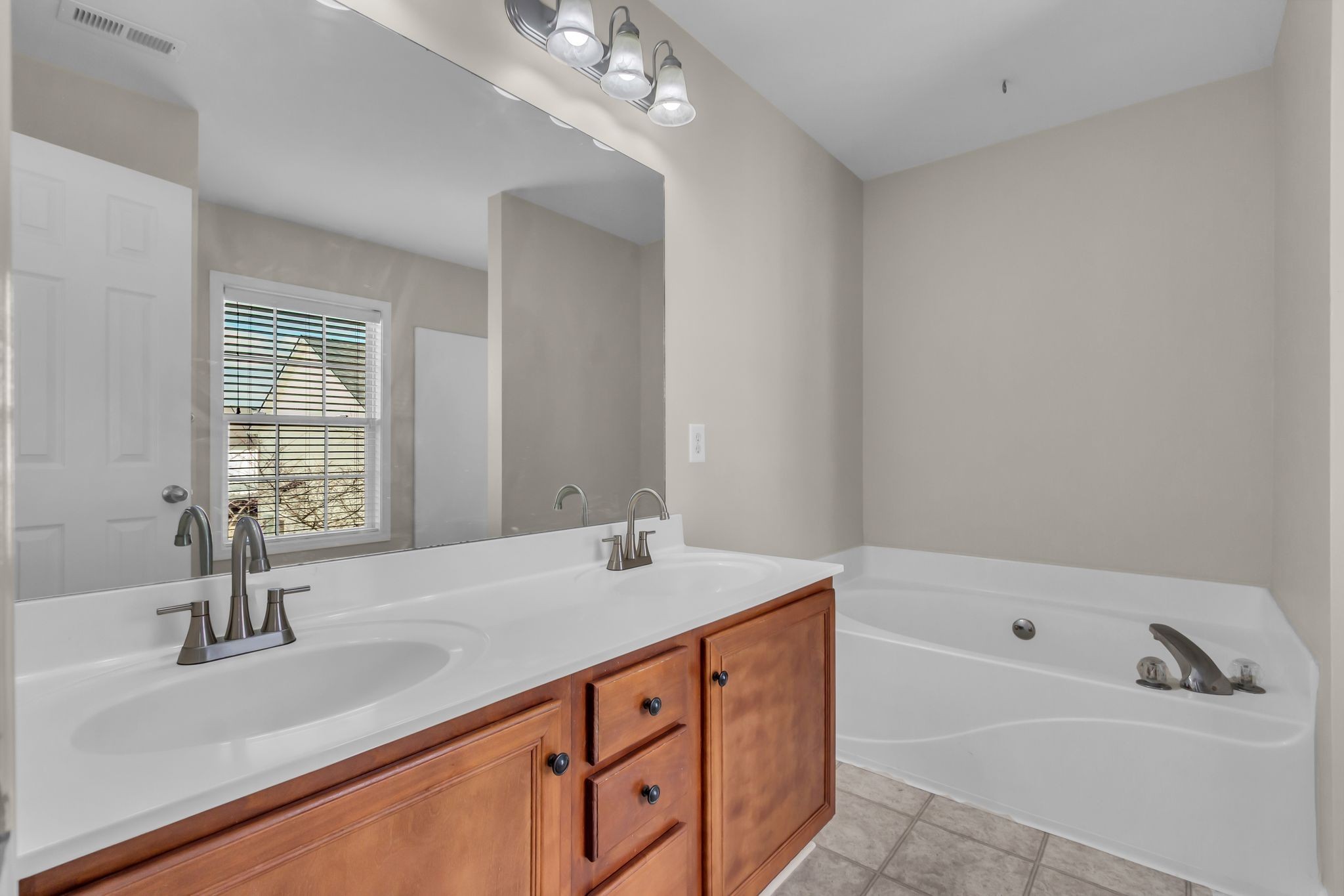 3008 Michael Lane Spring Hill, TN 37174 - Photo 18 of 33 a bathroom with a sink double vanity granite tub and a mirror