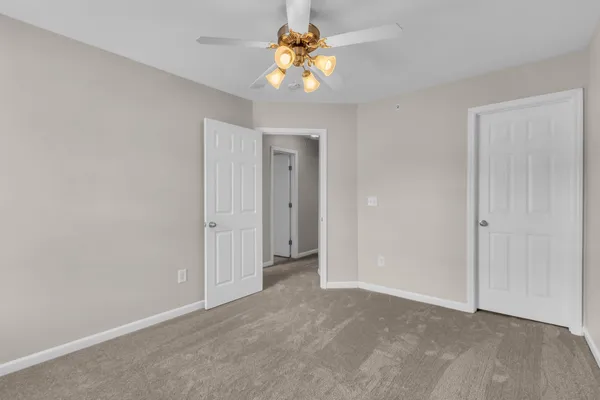 a view of a chandelier fan and closet in a room