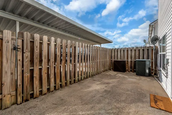 a view of backyard with barbeque grill with wooden fence