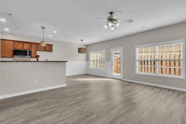 a view of an empty room with a kitchen