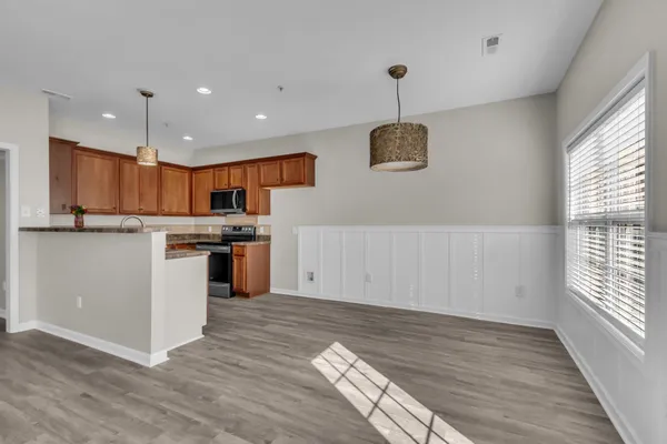 a kitchen with a sink window and stainless steel appliances