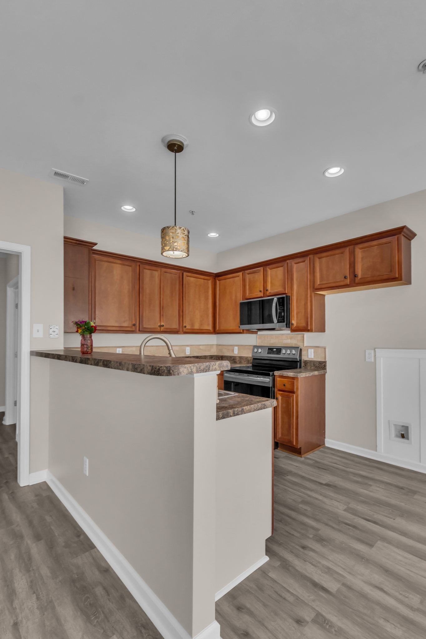 3008 Michael Lane Spring Hill, TN 37174 - Photo 8 of 33 a kitchen with stainless steel appliances granite countertop a refrigerator a sink dishwasher a s stove top oven a dining table and chairs with wooden floor