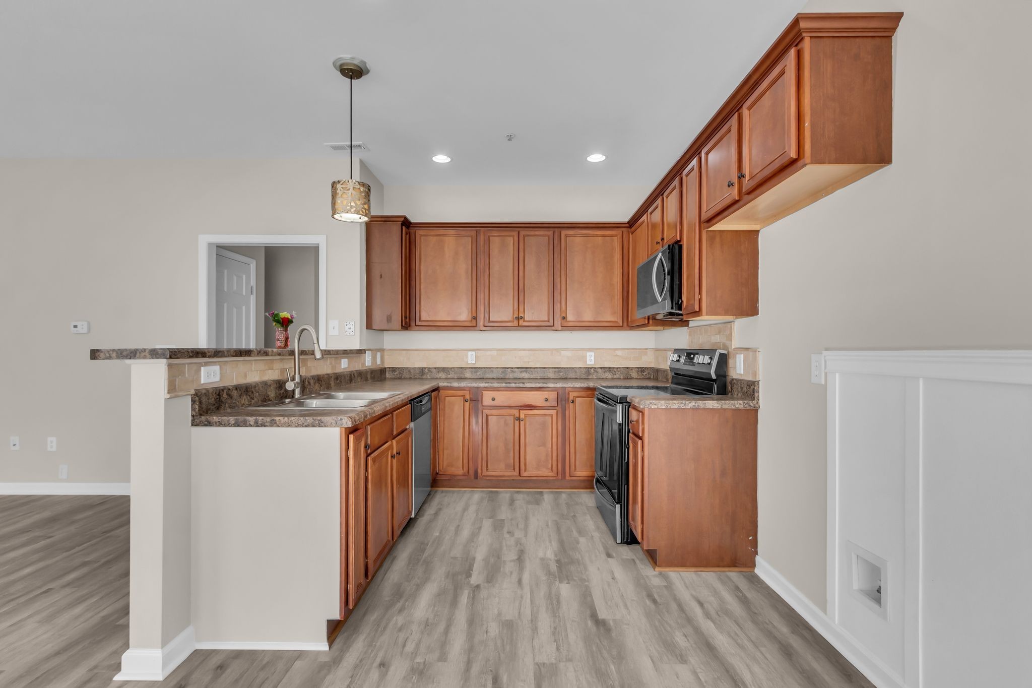 3008 Michael Lane Spring Hill, TN 37174 - Photo 9 of 33 a kitchen with kitchen island granite countertop wooden cabinets and white appliances