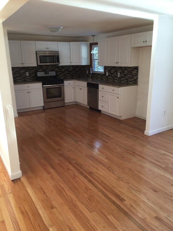 22 Winsor Road Billerica, MA 01821 - Photo 2 of 9 a kitchen with a sink and a stove top oven