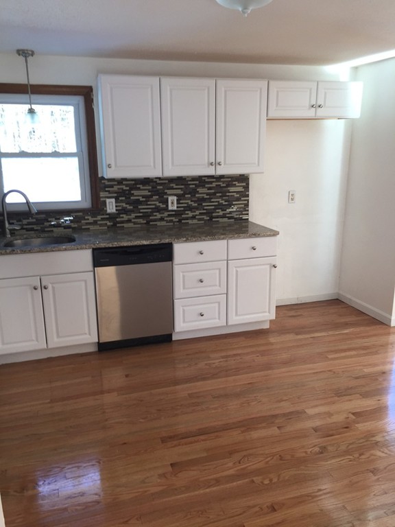 22 Winsor Road Billerica, MA 01821 - Photo 3 of 9 a kitchen with stainless steel appliances granite countertop a stove a sink and white cabinets