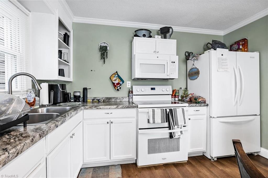 226 Friendly Avenue High Point, NC 27260 - Photo 14 of 38 The kitchen includes a full range, ample white cabinetry, and generous counter space, well suited to a shared household.