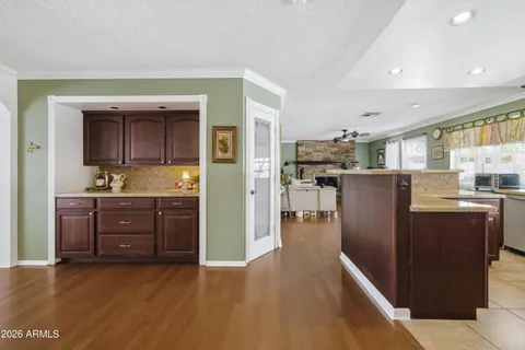a view of a dining room with furniture a chandelier and wooden floor