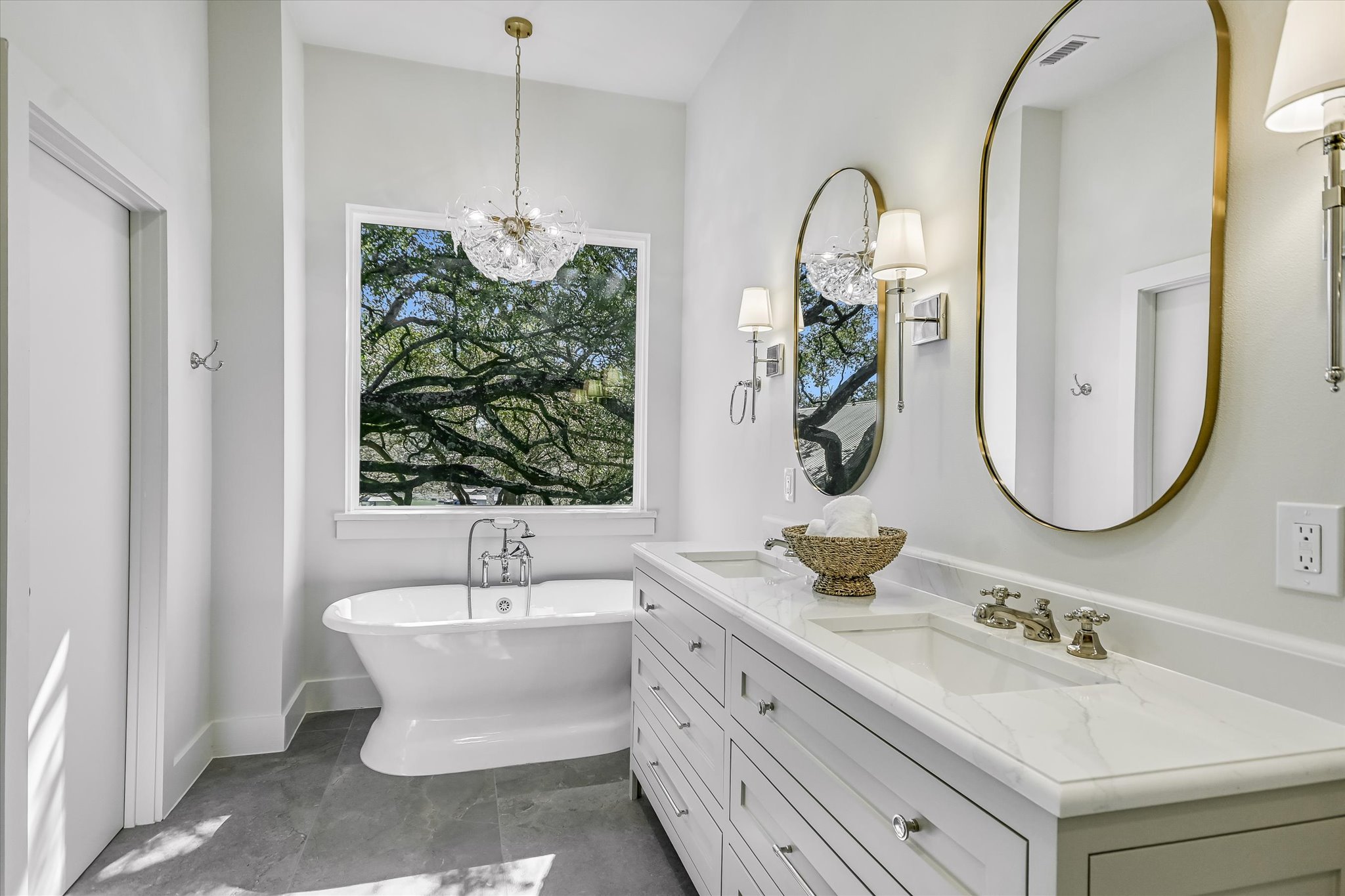 6111 Hudson Bend Road Austin, TX 78734 - Photo 36 of 40 Full bathroom with double vanity, a soaking tub, and a chandelier