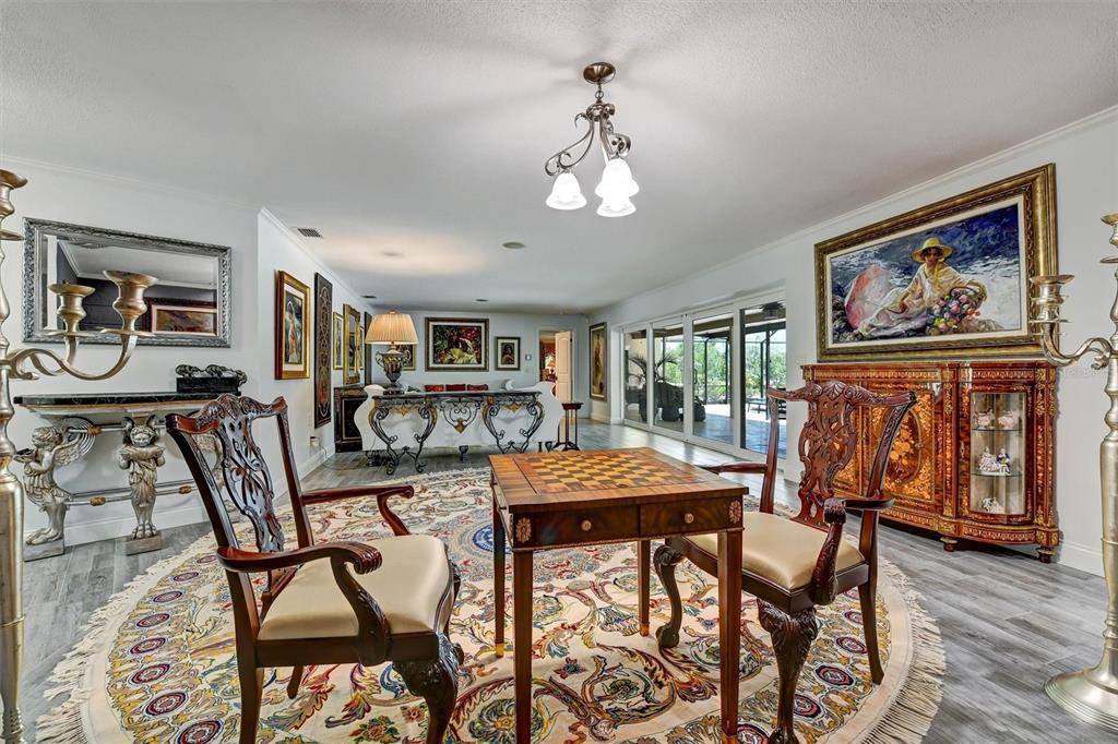 1875 Belleair Road Clearwater, FL 33764 - Photo 55 of 100 a view of a dining room with furniture wooden floor and chandelier