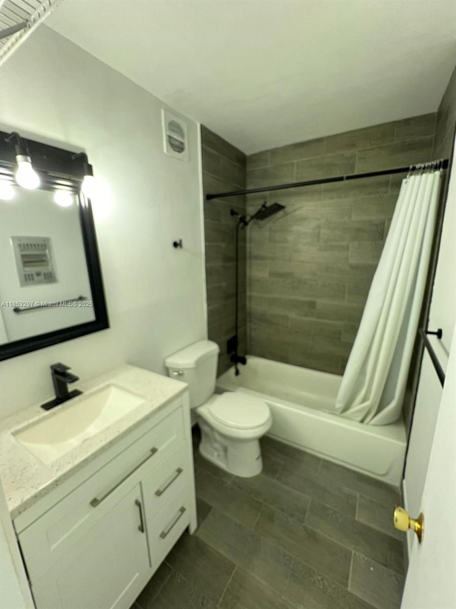 524 Washington Avenue, Unit 310 Miami Beach, FL 33139 - Photo 2 of 6 a bathroom with a double vanity sink toilet and shower