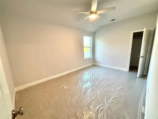 a view of a room with an empty space and a large tree