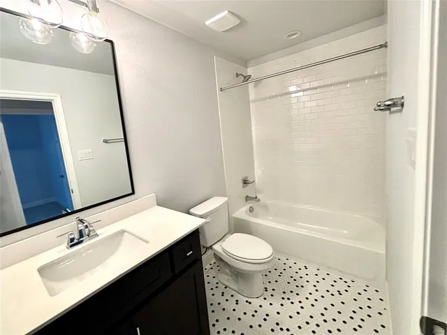 a view of a room with an empty space and a large tree