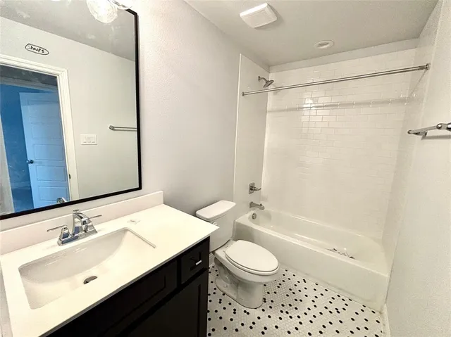 a view of an empty room with a fireplace and a large window