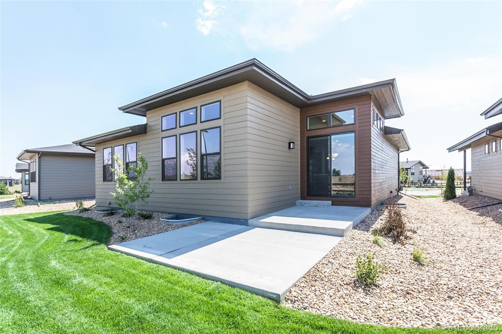 6768 Castello Street Timnath, CO 80547 - Photo 25 of 38 a front view of a house with a yard and garage