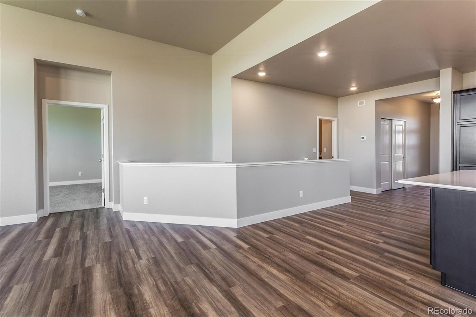 6768 Castello Street Timnath, CO 80547 - Photo 27 of 38 wooden floor in an empty room with a window