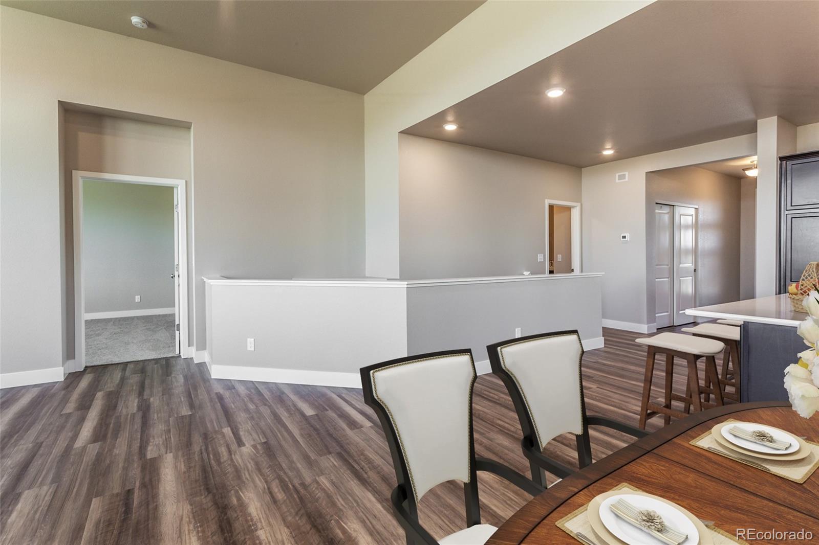 6768 Castello Street Timnath, CO 80547 - Photo 3 of 38 a view of a livingroom with furniture window and wooden floor