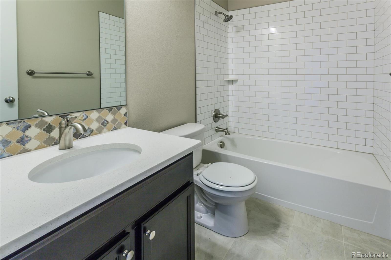 6768 Castello Street Timnath, CO 80547 - Photo 31 of 38 a bathroom with a sink and a mirror