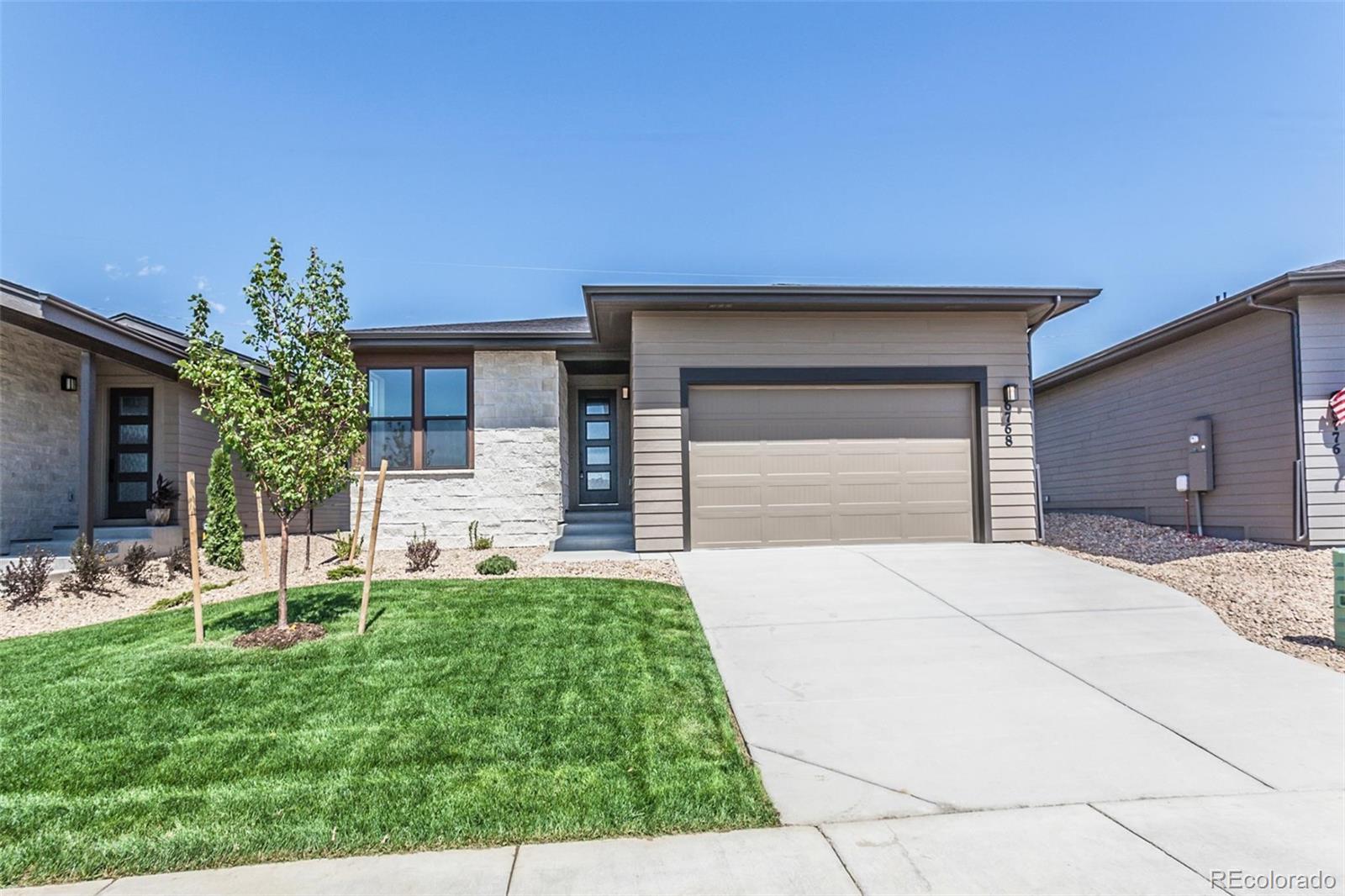 6768 Castello Street Timnath, CO 80547 - Photo 37 of 38 a front view of a house with a yard and garage