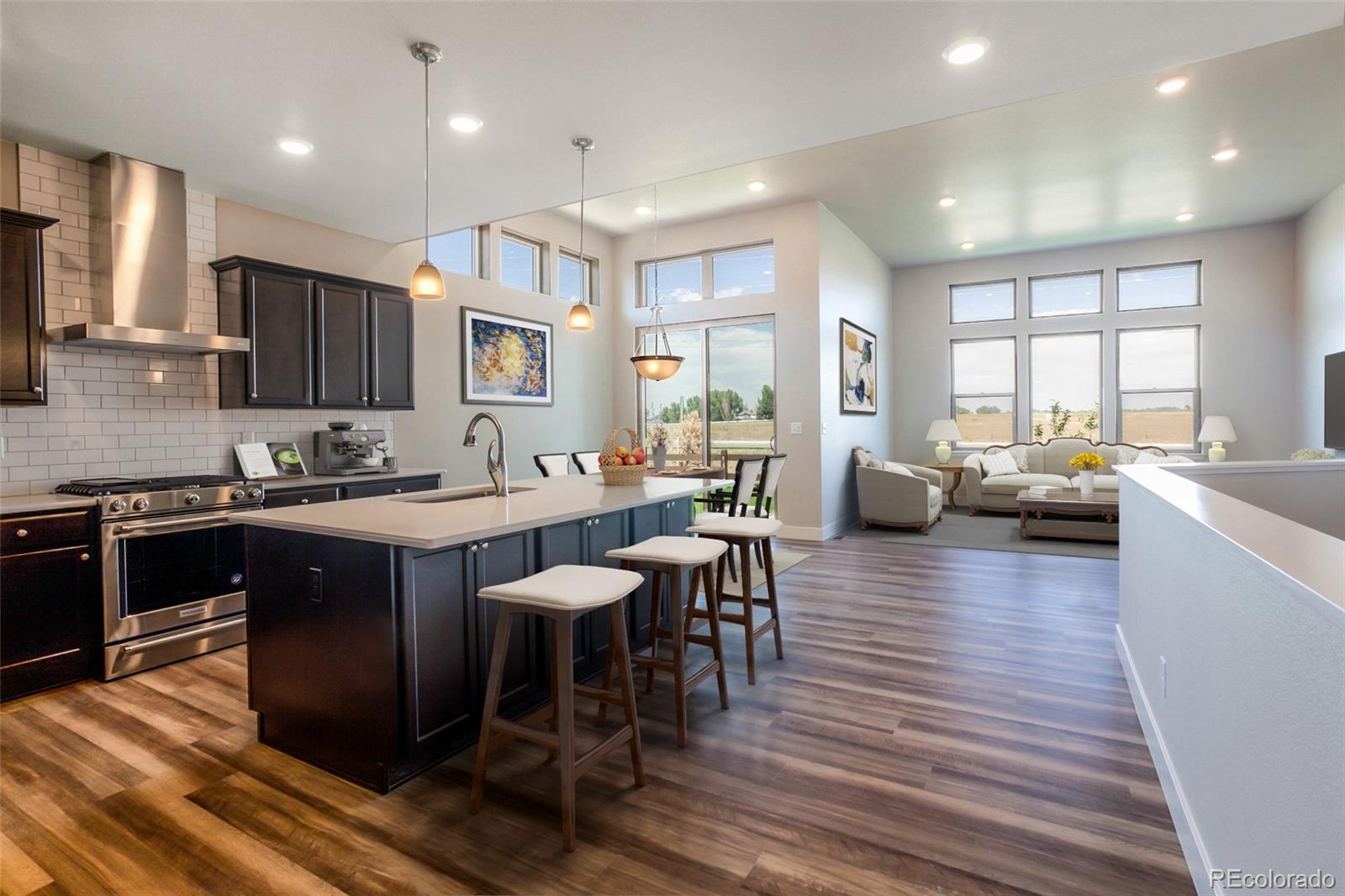 6768 Castello Street Timnath, CO 80547 - Photo 6 of 38 a large kitchen with lots of counter space dining table and chairs