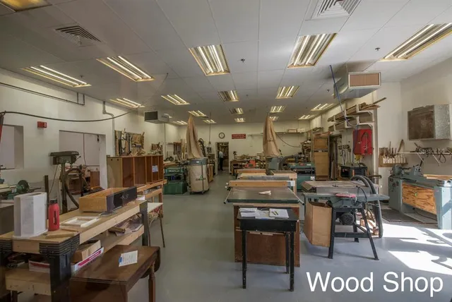 a view of a house with a small yard and potted plants