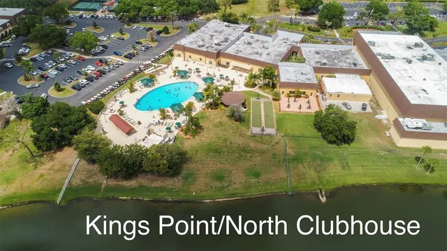 a living room with lots of furniture wooden floor and a chandelier