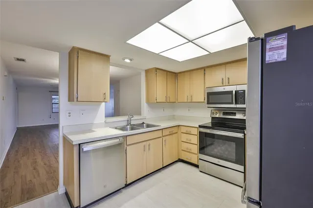 a kitchen with stainless steel appliances a refrigerator and a sink