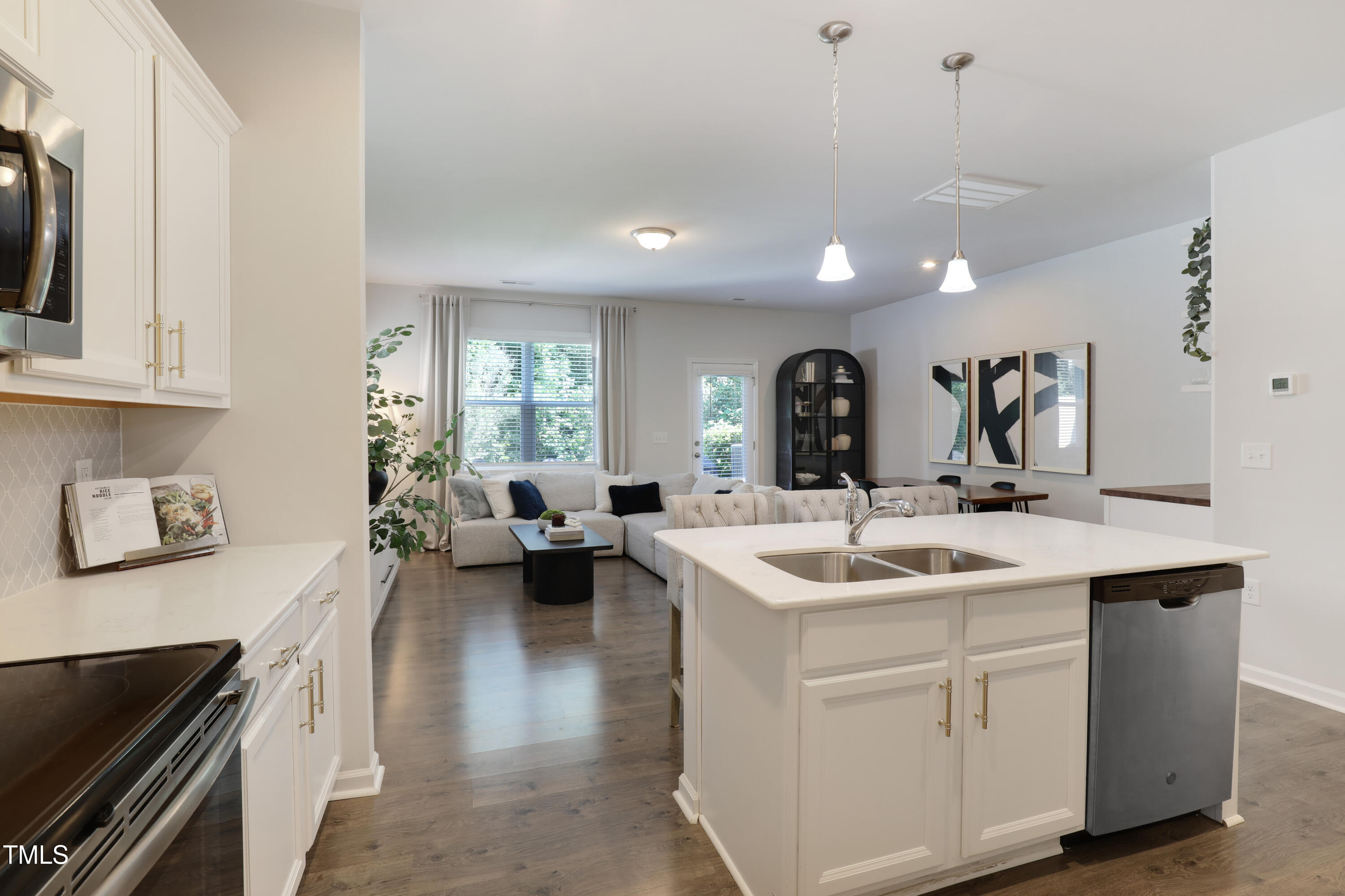 3636 Water Mist Lane Raleigh, NC 27604 - Photo 13 of 28 a kitchen with a sink stove and cabinets