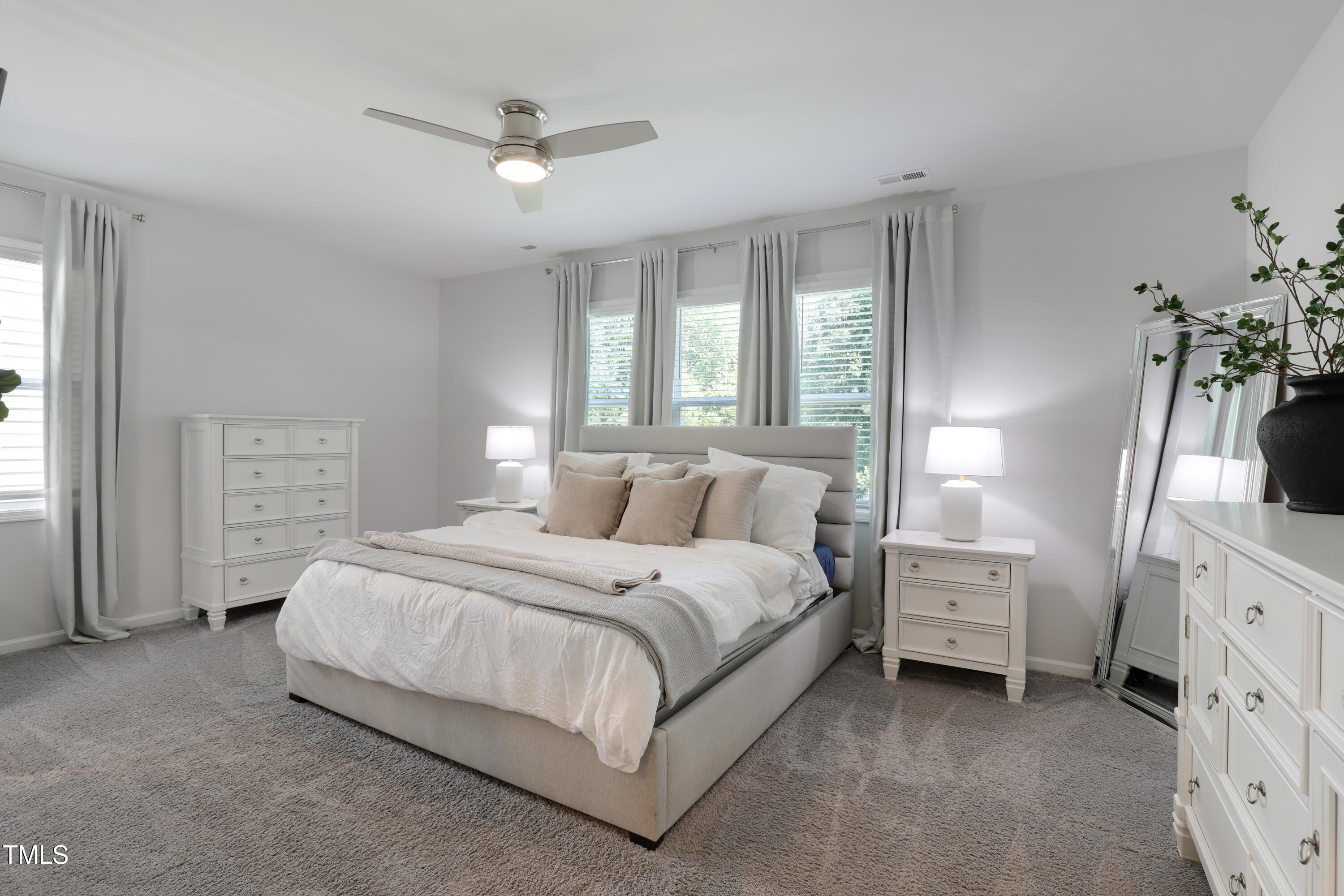 3636 Water Mist Lane Raleigh, NC 27604 - Photo 16 of 28 a bedroom with a bed a dresser and a window