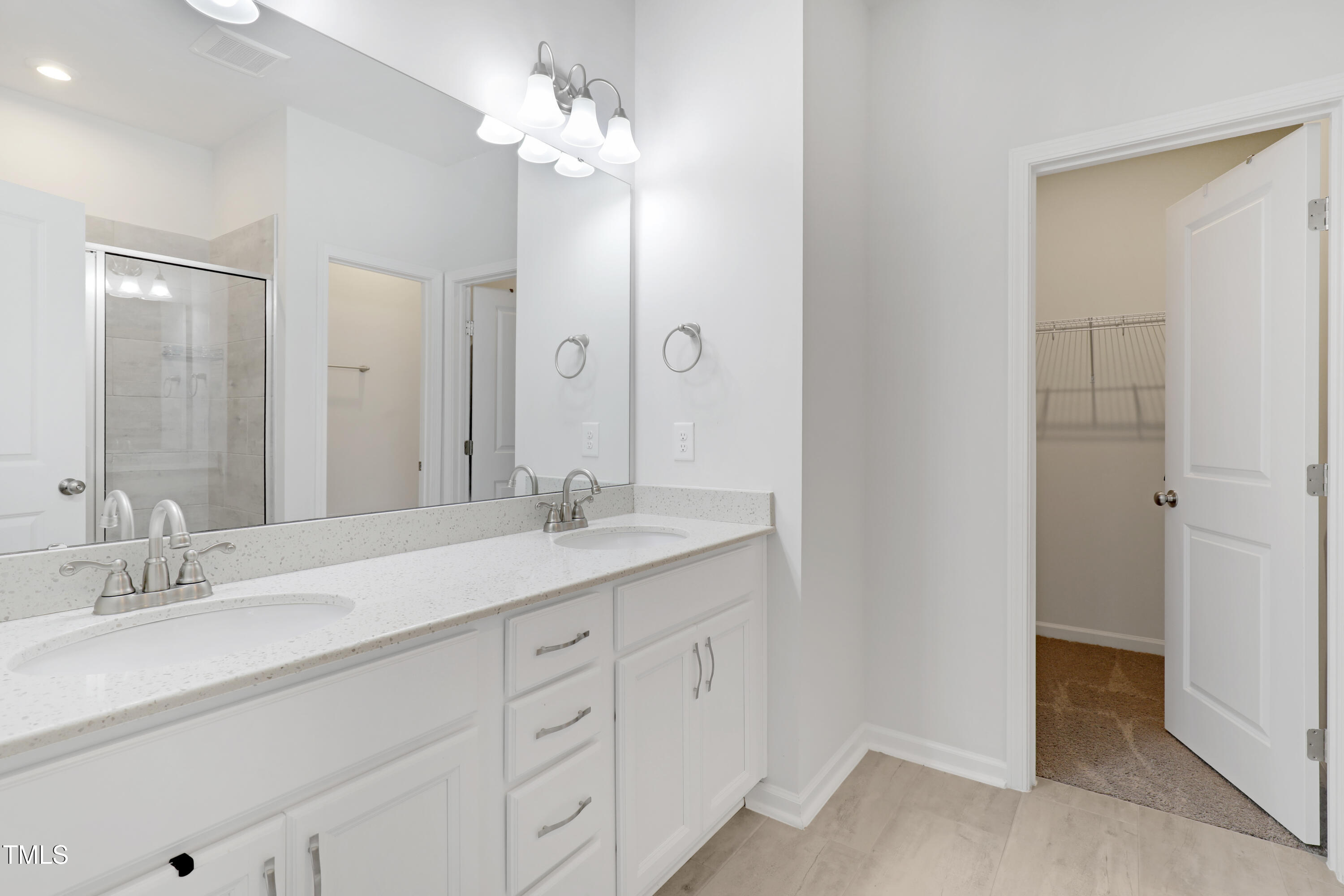 3636 Water Mist Lane Raleigh, NC 27604 - Photo 19 of 28 a bathroom with a sink double vanity and a mirror
