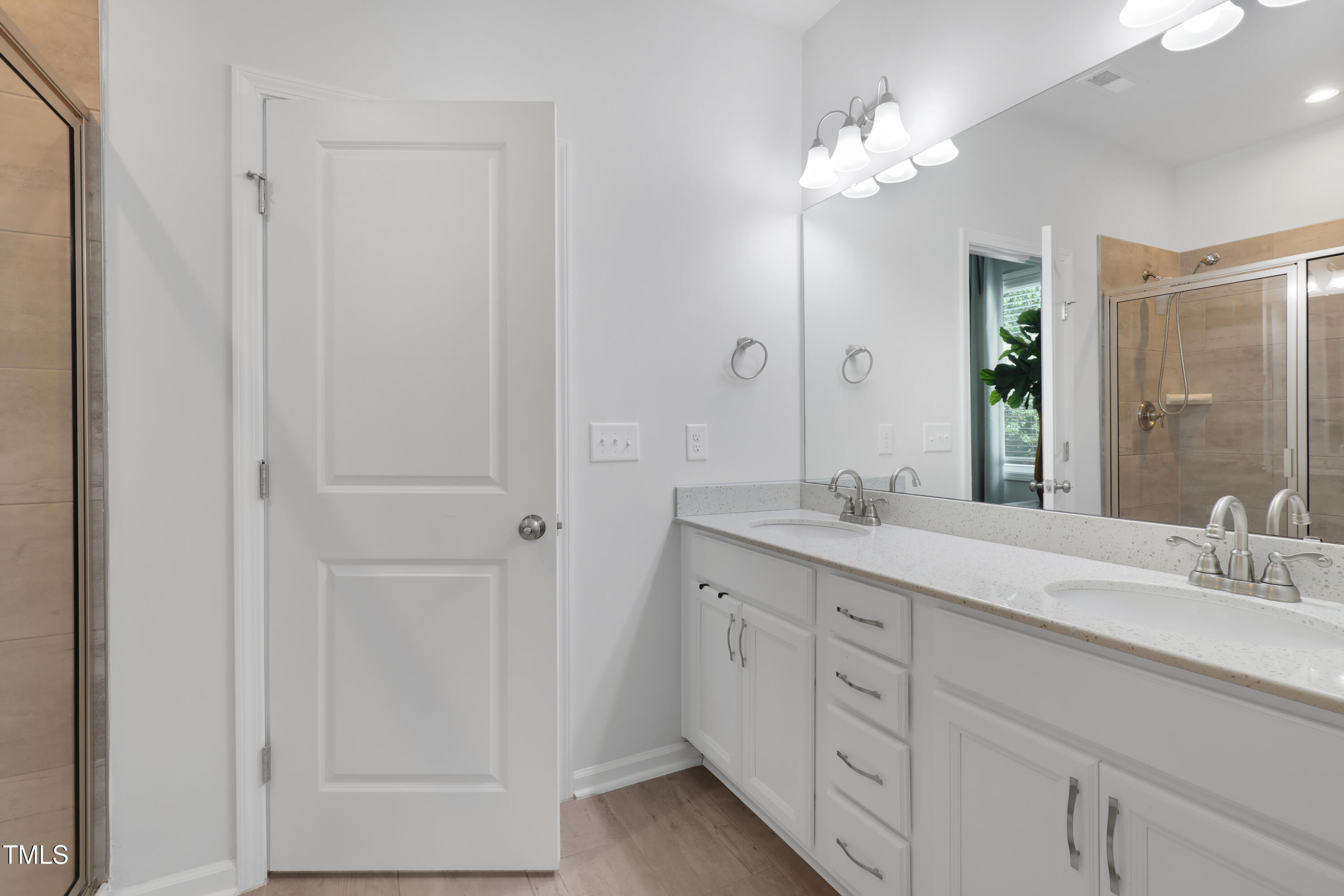 3636 Water Mist Lane Raleigh, NC 27604 - Photo 20 of 28 a bathroom with a double vanity sink and a mirror