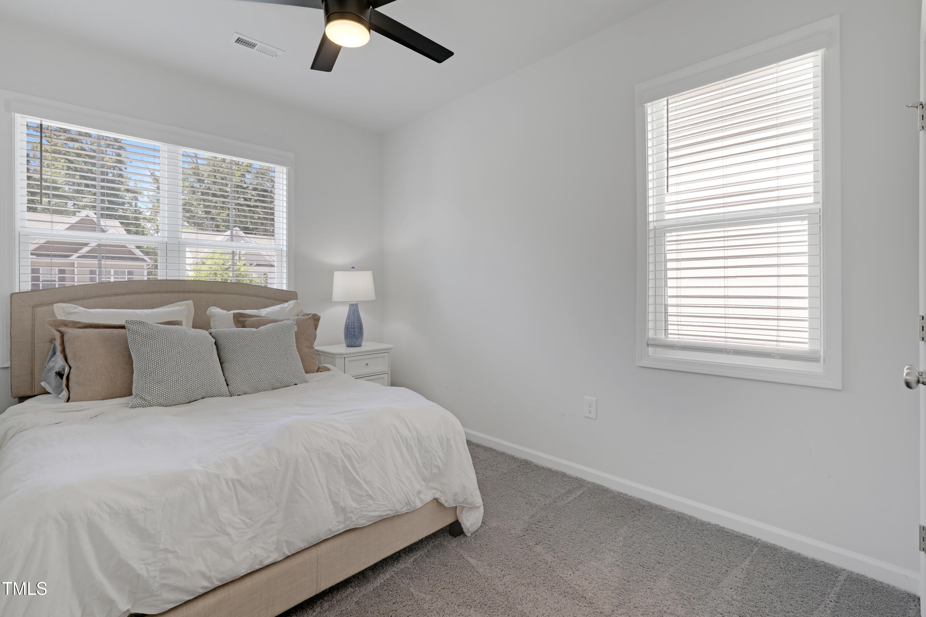 3636 Water Mist Lane Raleigh, NC 27604 - Photo 21 of 28 a large bed sitting in a bedroom next to a window