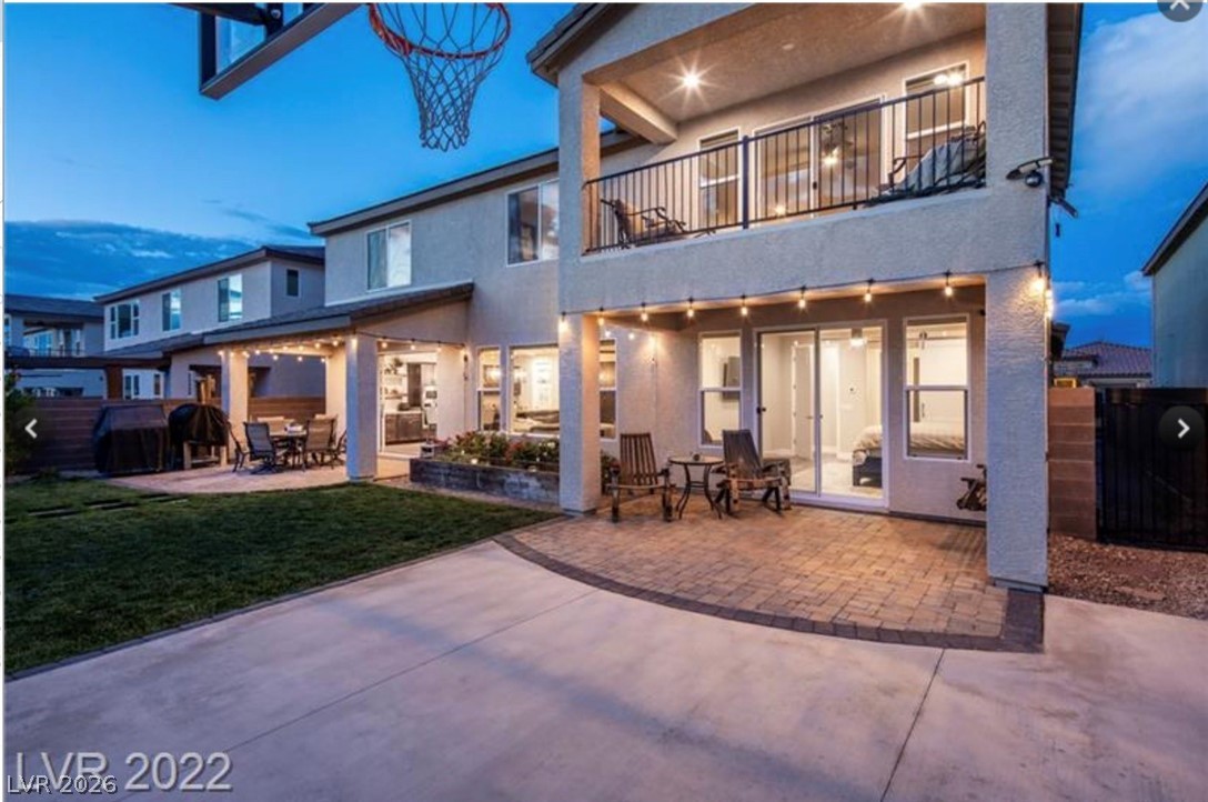 4631 Amazing View Street Las Vegas, NV 89129 - Photo 23 of 33 A well-designed backyard with multiple seating areas and a second-story balcony offers ideal outdoor living.