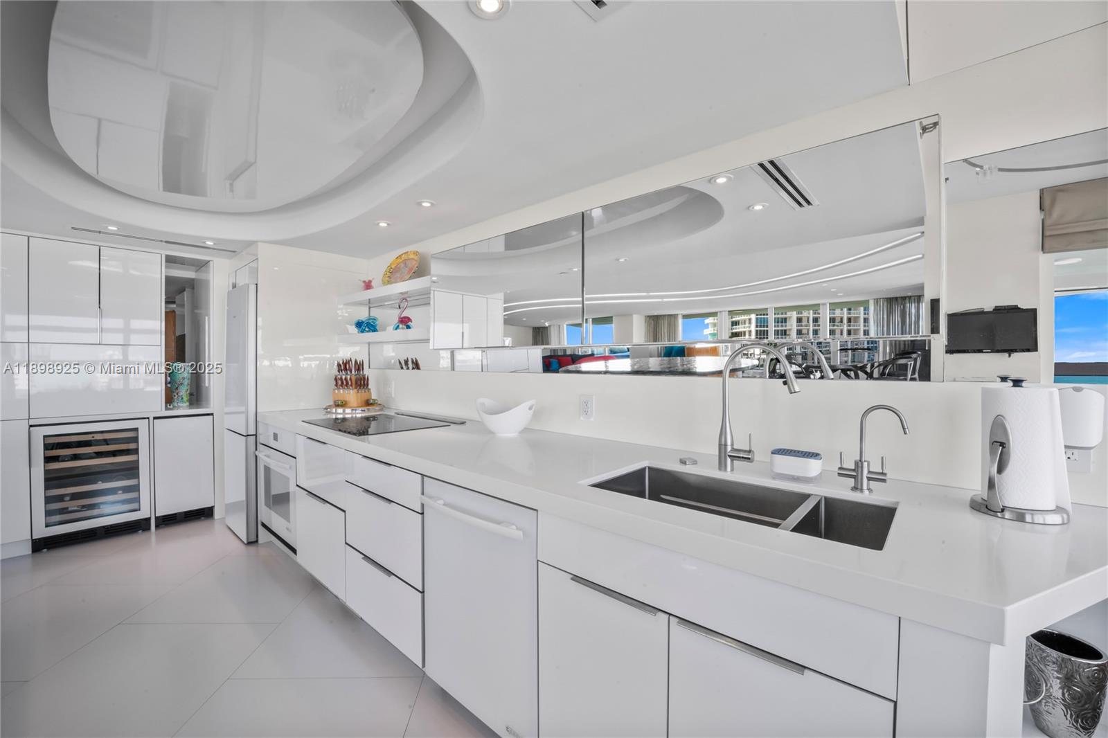 400 South Pointe Drive, Unit 910 Miami Beach, FL 33139 - Photo 16 of 44 a kitchen with sink a stove and cabinets