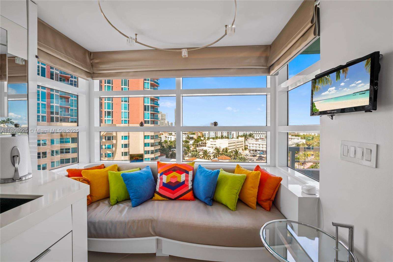 400 South Pointe Drive, Unit 910 Miami Beach, FL 33139 - Photo 19 of 44 a living room with blue couches and coffee table