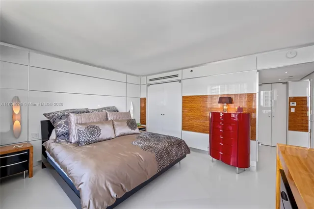 a bed room with a bed furniture and a flat screen tv