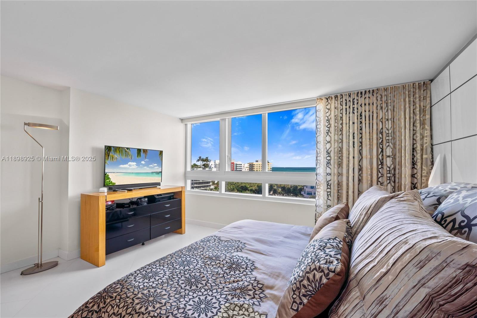 400 South Pointe Drive, Unit 910 Miami Beach, FL 33139 - Photo 31 of 44 a bed room with a bed furniture and a flat screen tv