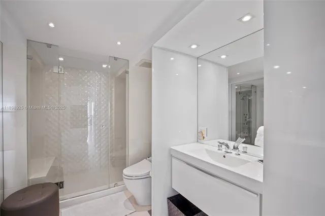 a bathroom with a double vanity sink toilet and shower