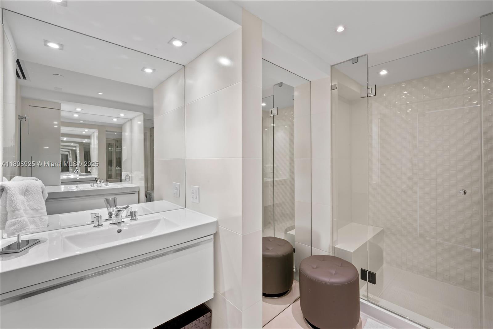 400 South Pointe Drive, Unit 910 Miami Beach, FL 33139 - Photo 33 of 44 a bathroom with a double vanity sink toilet and shower