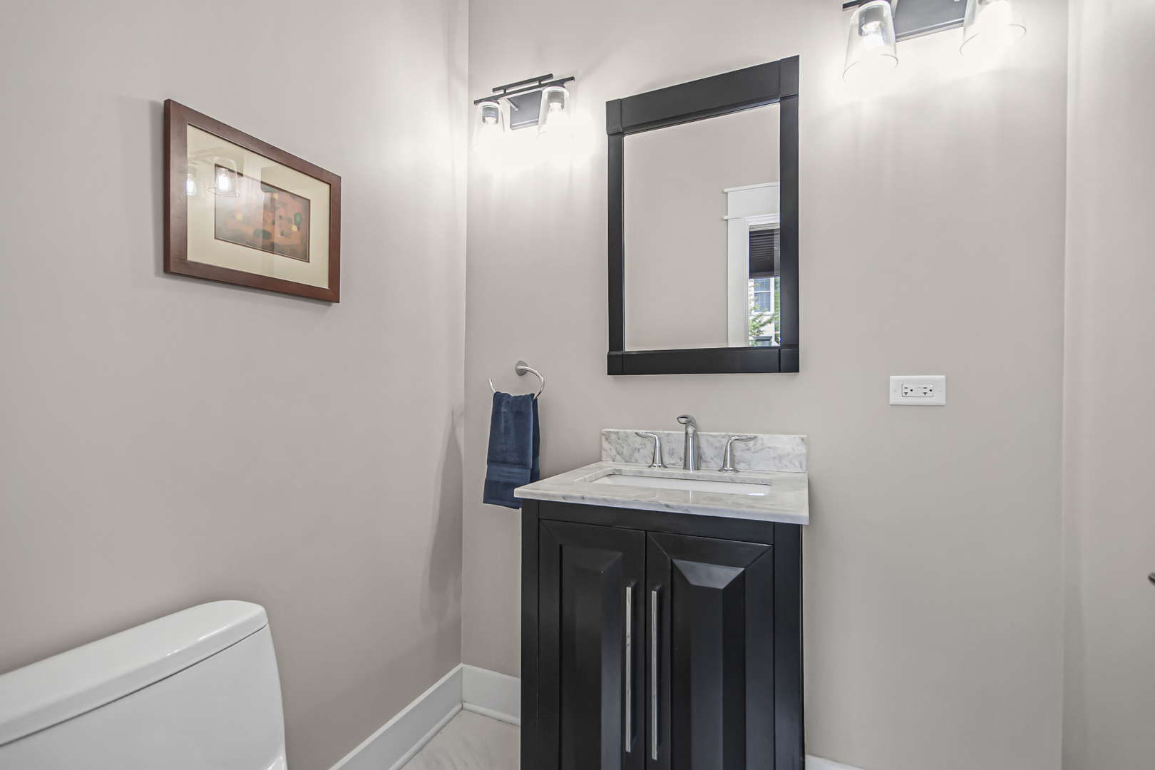 8146 Lincoln Avenue Skokie, IL 60077 - Photo 20 of 25 a bathroom with a toilet sink and mirror