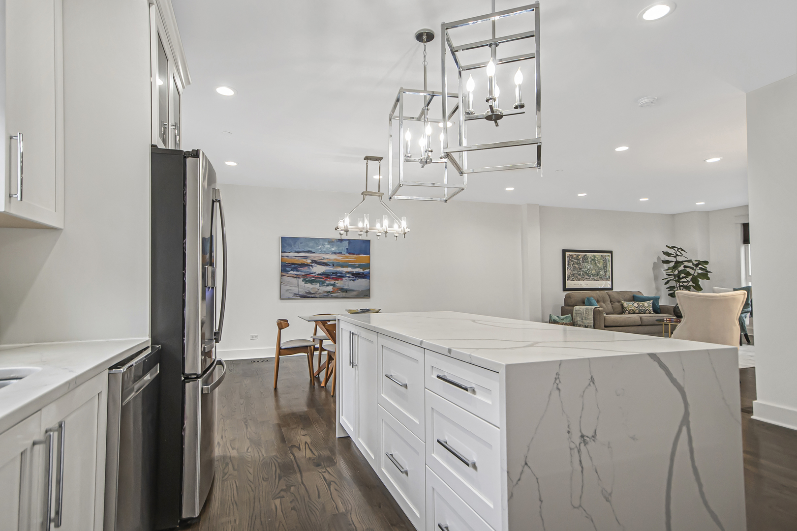 8146 Lincoln Avenue Skokie, IL 60077 - Photo 9 of 25 a kitchen with a refrigerator a sink dishwasher a dining table and chairs with wooden floor