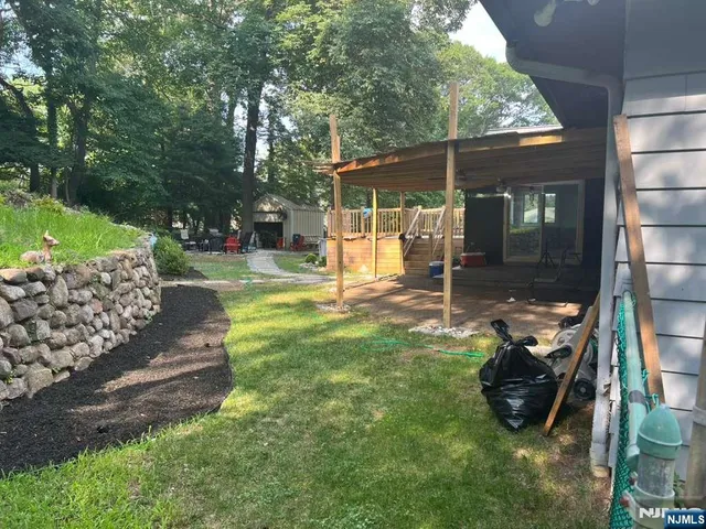 a view of a chair and table in backyard