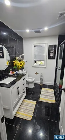 a kitchen with sink and view of living room
