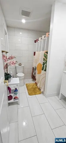 a bedroom with a bed and a potted plant