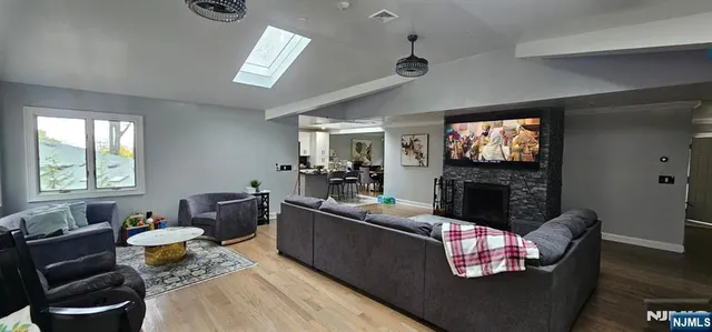 a living room with furniture a fireplace and a flat screen tv