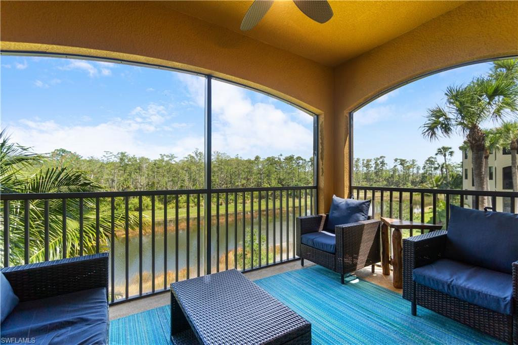 9590 Trevi Court, Unit 5337 Naples, FL 34113 - Photo 14 of 14 a balcony with wooden floor and outdoor seating