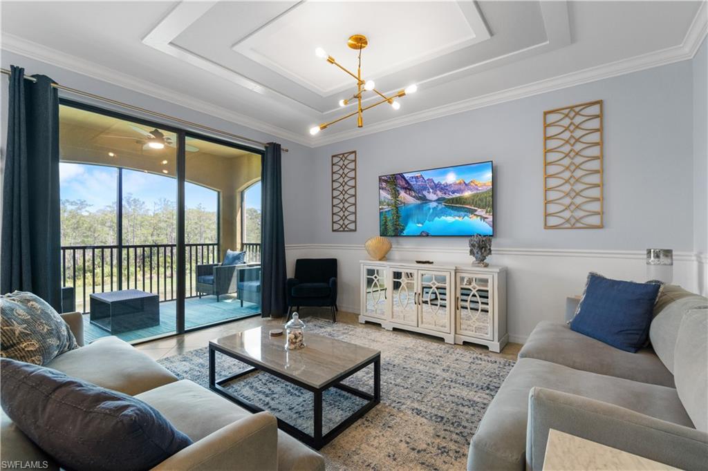 9590 Trevi Court, Unit 5337 Naples, FL 34113 - Photo 2 of 14 a living room with furniture a rug and a flat screen tv