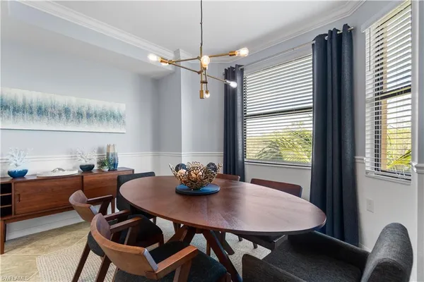 a view of a dining room with furniture and window